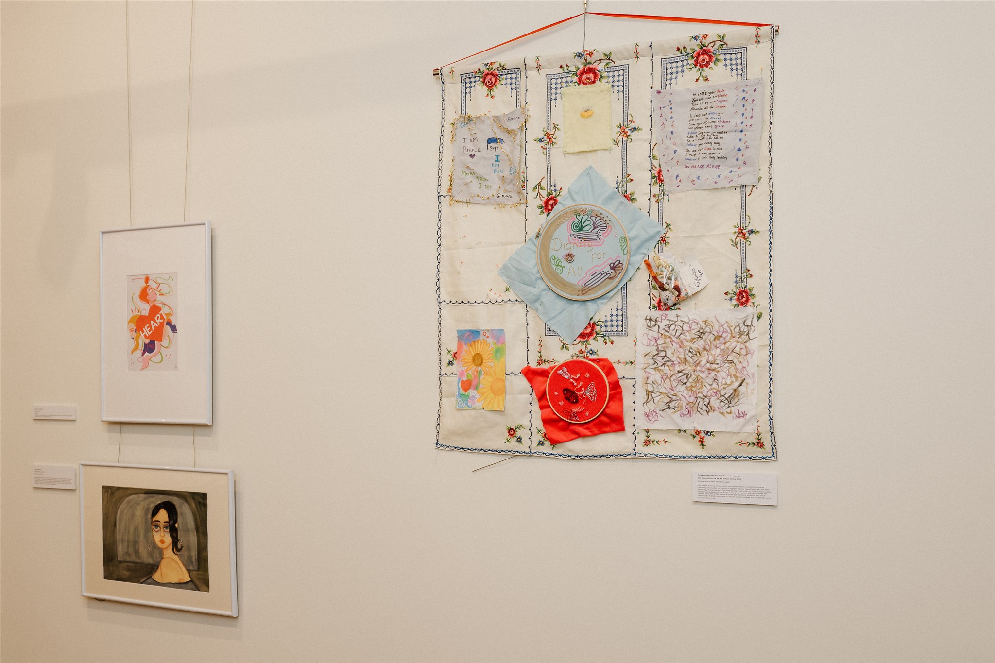 Patterned textiles and drawings created by different individuals are combined and displayed in one artwork.