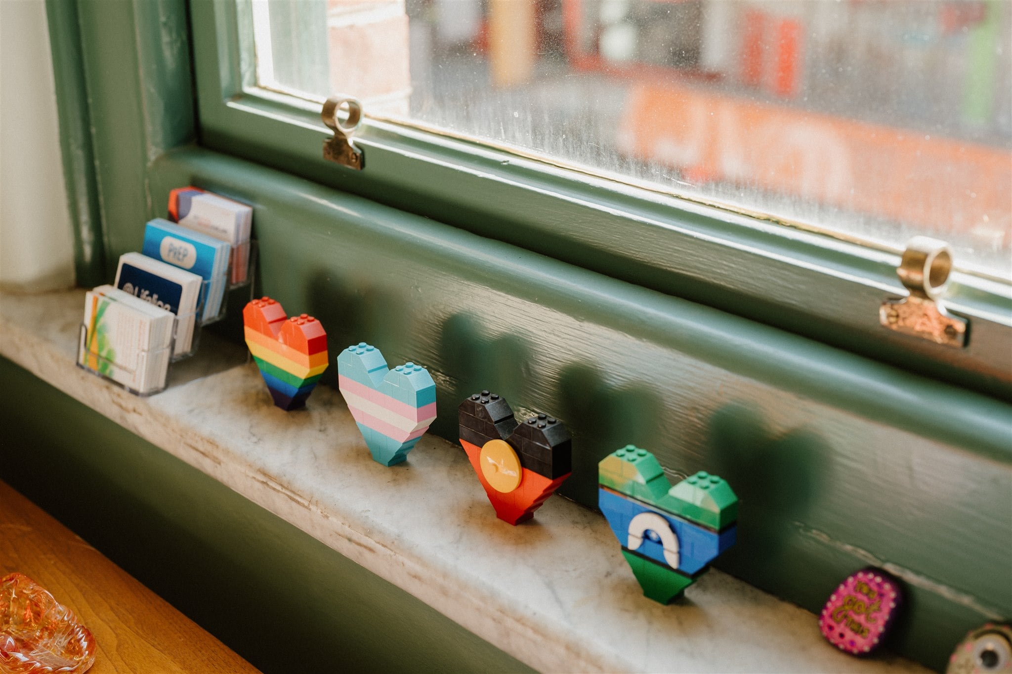 Hearts made from lego in the colours of different inclusive flags. Including the Aboriginal flag, Torres Strait Islander flag and the transgender pride flag.